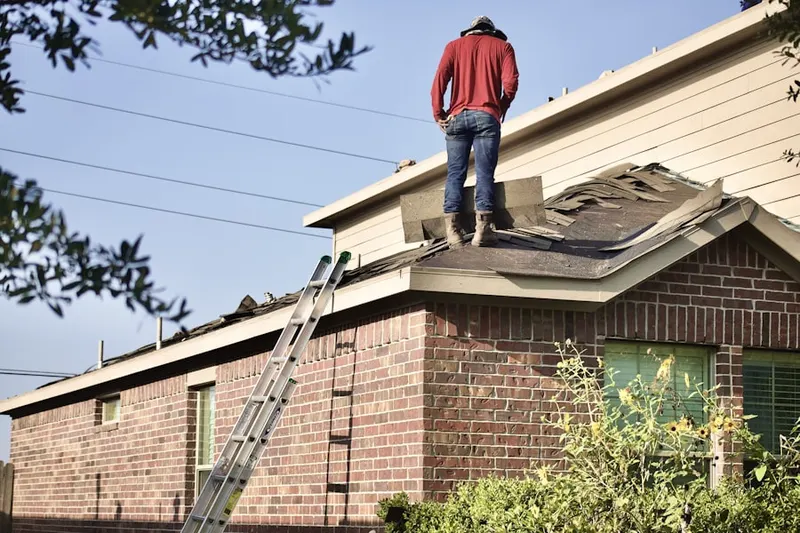 Professional roofer working on a residential roof in North Burlington